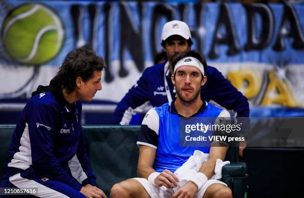 Leonardo Meyer of Argentina reacts with team captain Gaston Gaudio during a break against Daniel Galan of Colombia during the game 1 of their Copa...