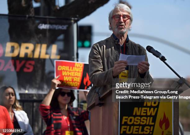 Tom Waterston introduces a community activist speaker at during a rally against the fossil fuel industry. The rally was organized by Greenpeace USA...