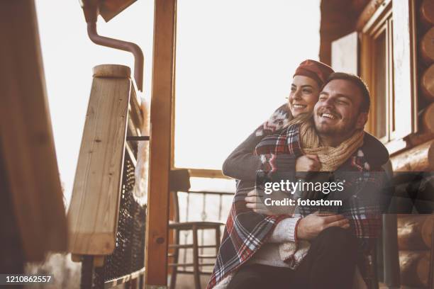 emotional moment of an affectionate couple in during vacation. - wooden hut stock pictures, royalty-free photos & images