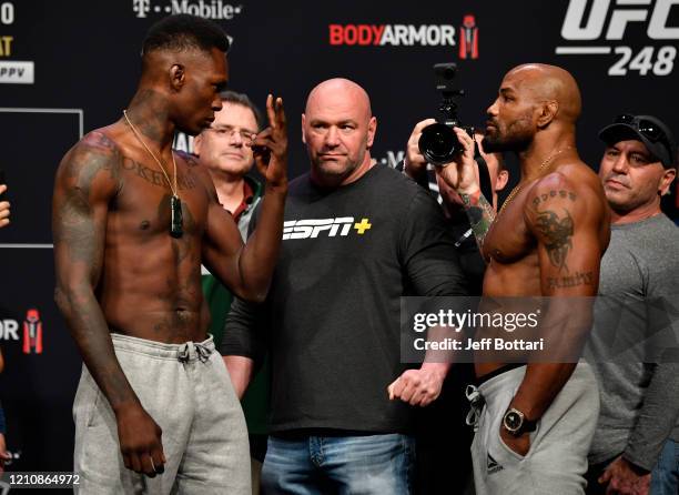 Opponents Israel Adesanya of Nigeria and Yoel Romero of Cuba face off during the UFC 248 weigh-in at T-Mobile Arena on March 06, 2020 in Las Vegas,...