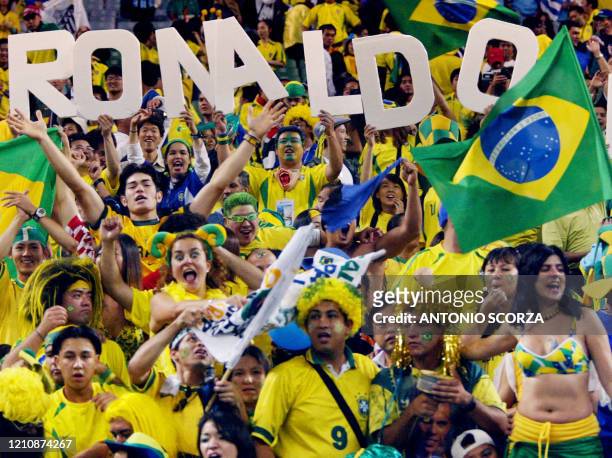 Brazilian fans hoist the name of No. 9, Brazil's forward Ronaldo, after he scored the winning goal against Turkey in match 62 of the 2002 FIFA World...