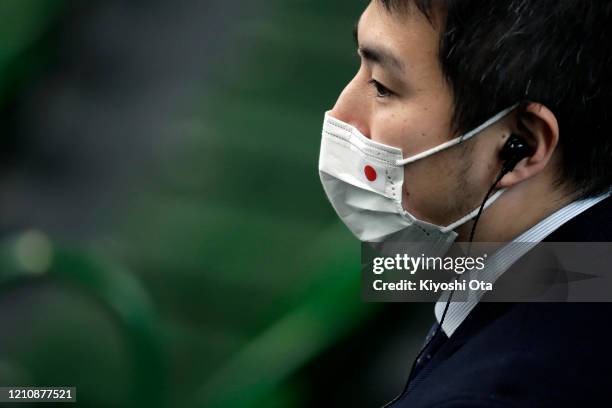 Staff member wearing a face mask is seen during the singles match between Yasutaka Uchiyama of Japan and Roberto Quiroz of Ecuador on day one of the...