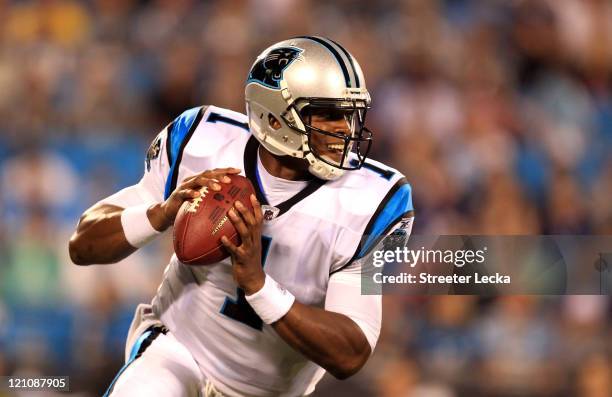 Cam Newton of the Carolina Panthers runs with the ball during their preseason game against the New York Giants at Bank of America Stadium on August...