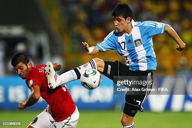 Sergio Oliveira of Portugal is challenged by Rodrigo Battaglia of Argentina during the FIFA U-20 World Cup 2011 quarter final match between Portugal...