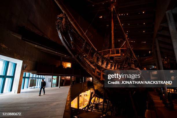 Museum staff walks next to the Swedish warship Vasa, on April 24 at the Vasa Museum in Stockholm, 59 years after Vasa broke the surface in 1961 after...