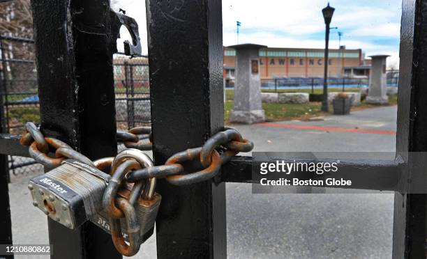 Lock on the gate to Veteran's Memorial Stadium, next to Lawrence High School in Lawrence, MA, where high school track meets are usually held, on...