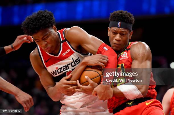 Rui Hachimura of the Washington Wizards and De'Andre Hunter of the Atlanta Hawks battle for possession during the second half at Capital One Arena on...