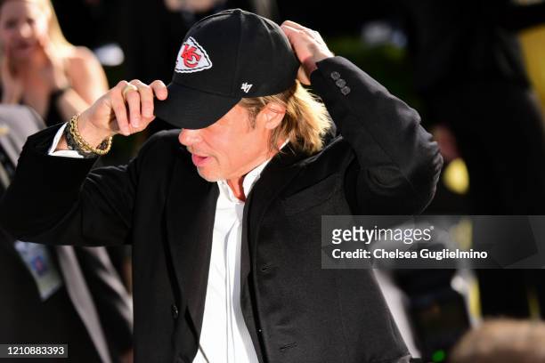 Actor Brad Pitt puts on a Kansas City Chiefs hat at the 26th annual Screen Actors Guild Awards at The Shrine Auditorium on January 19, 2020 in Los...