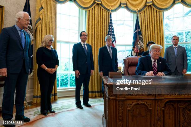 President Donald Trump participates in a signing ceremony for H.R.266, the Paycheck Protection Program and Health Care Enhancement Act, with members...