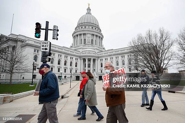 Protesters against the coronavirus shutdown rally in front of State Capitol in Madison, Wisconsin, on April 24, 2020. The coronavirus pandemic soared...