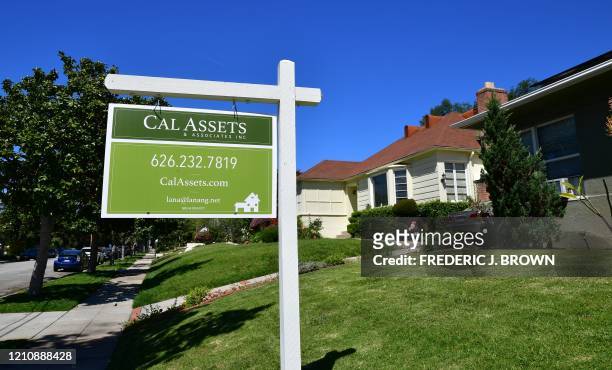 For sale sign is seen near a house for sale in South Pasadena, California on April 24, 2020. - The coronavirus pandemic has worsened the US housing...