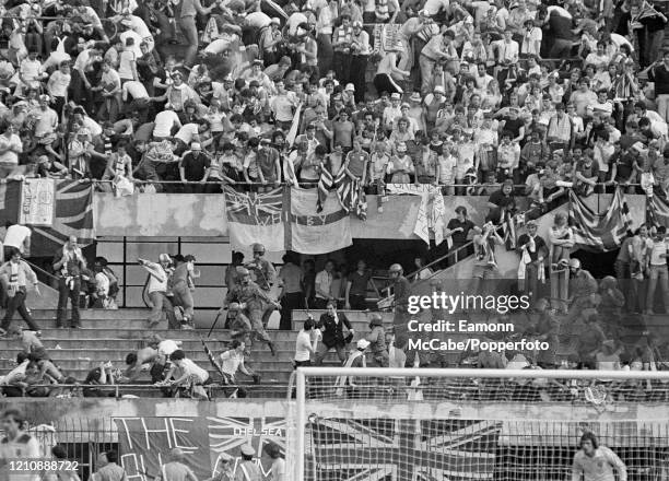 England fans fight with police behind Ray Clemence's goal during the UEFA Euro 1980 Group 2 match between Belgium and England at the Stadio Comunale...