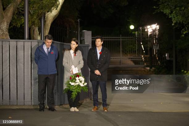 New Zealand Prime Minister Jacinda Ardern stands at dawn on the driveway of Premier House with her father Ross Ardern, left and partner Clarke...