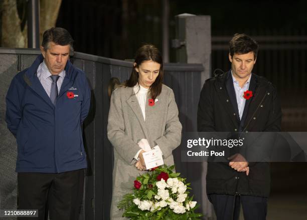 New Zealand Prime Minister Jacinda Ardern stands at dawn on the driveway of Premier House with her father Ross Ardern, left and partner Clarke...