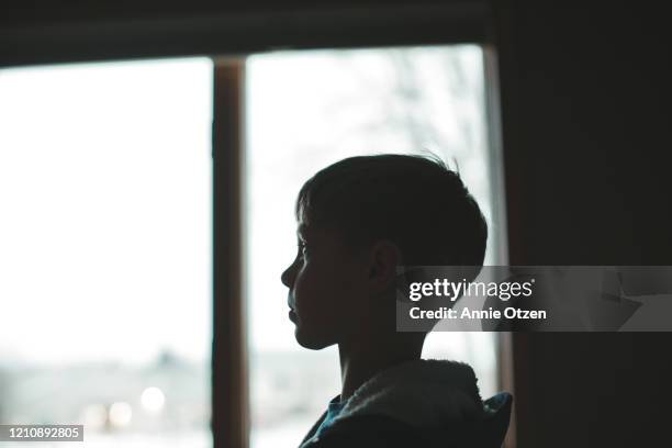 profile view of boy - back lit portrait stock pictures, royalty-free photos & images