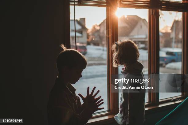 children silhouetted by window - unrecognizable person stock pictures, royalty-free photos & images