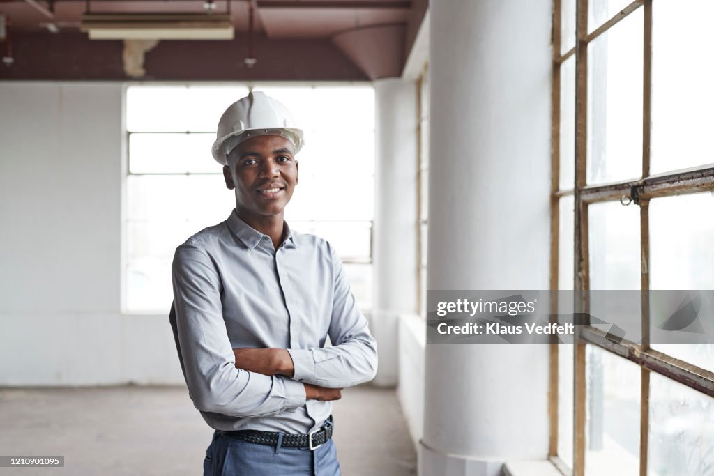 Portrait of male engineer standing in new office