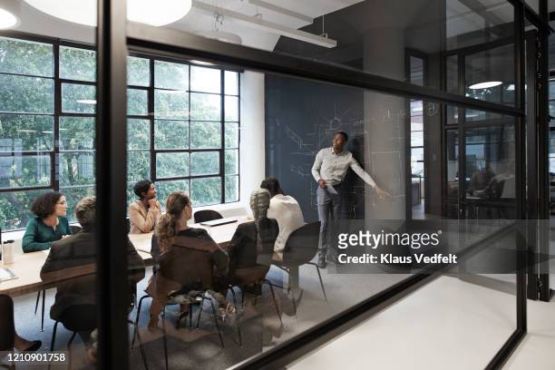 businessman with coworkers in conference room - business meeting stockfoto's en -beelden