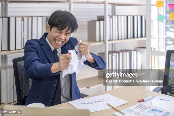 people, business and emotions concept -young man tearing documents with frustrated facial expression - tearing your hair out photos et images de collection