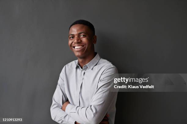 portrait of businessman against wall at workplace - young man portrait bildbanksfoton och bilder