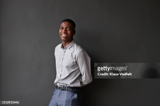 portrait of entrepreneur against wall at workplace - three quarter length stock pictures, royalty-free photos & images