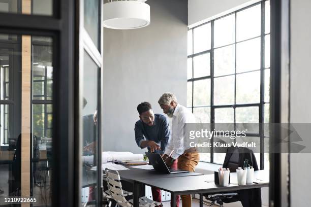 entrepreneurs discussing in modern office - architect stock pictures, royalty-free photos & images