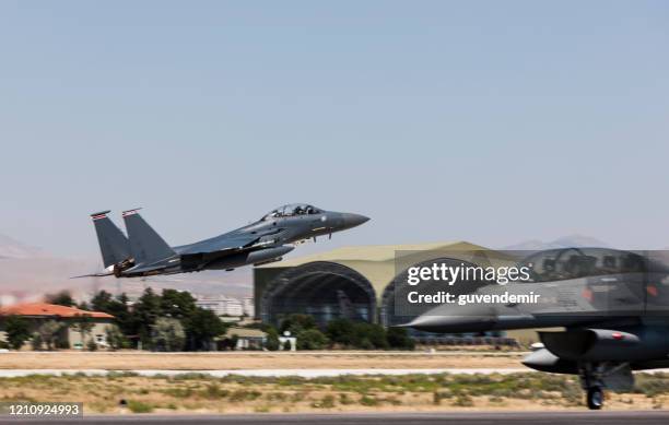 f-15 eagle fighter plane taking off - air force base stock pictures, royalty-free photos & images