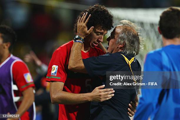 Head coach Ilidio Vale of Portugal hugs Tiago Ferreira after the FIFA U-20 World Cup 2011 quarter final match between Portugal and Argentina at...