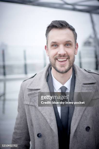 a smart casual business man standing in the rain laughing - casual menswear stock pictures, royalty-free photos & images