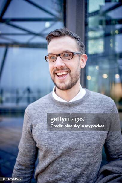 a smart casual business man laughing while wearing eyeglasses outside in the rain - menswear bildbanksfoton och bilder