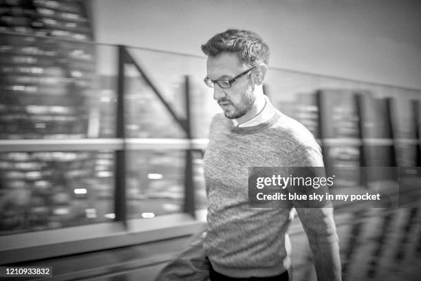 a smart casual business man in a hurry walking through the rain - casual menswear stock pictures, royalty-free photos & images