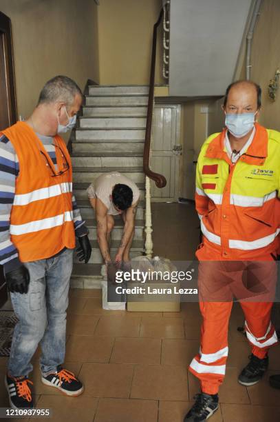 Men SVS Pubblica Assistenza volunteers deliver solidarity food shopping bags for the coronavirus emergency on April 24, 2020 in Livorno, Italy. Italy...