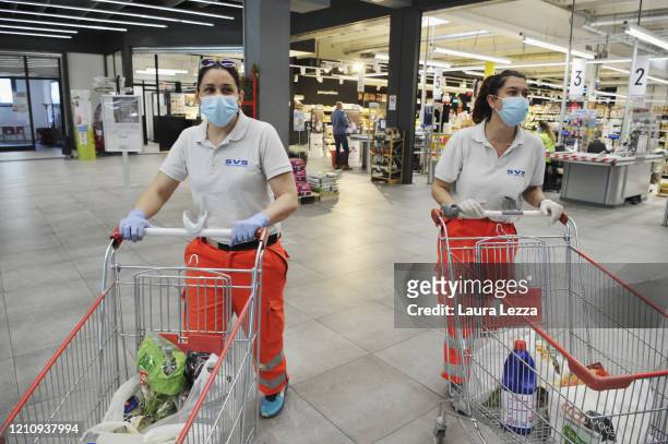Two SVS Pubblica Assistenza volunteers prepare solidarity food shopping bags in a Supermarket for the coronavirus emergency on April 24, 2020 in...