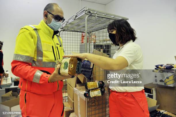 Two SVS Pubblica Assistenza volunteers prepare solidarity food shopping bags for the coronavirus emergency on April 24, 2020 in Livorno, Italy. Italy...
