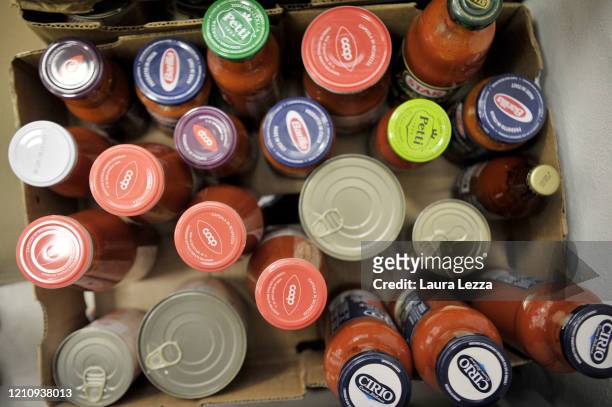 Many tomato sauces to prepare solidarity food shopping bags for the coronavirus emergency inside SVS Pubblica Assistenza on April 24, 2020 in...