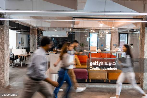 business people walking down the hallway - busy office stock pictures, royalty-free photos & images