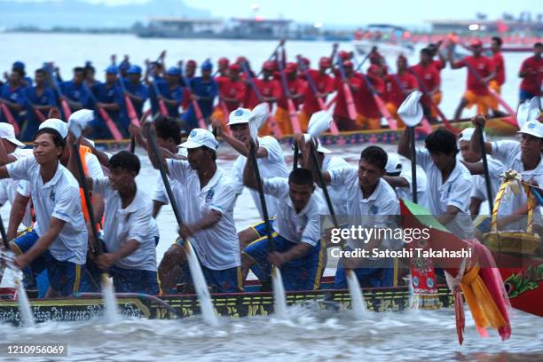 Cambodian dragon boat crew members row their boat on the Tonle Sap river during the final day of the Water Festival boat race. The country's annual...