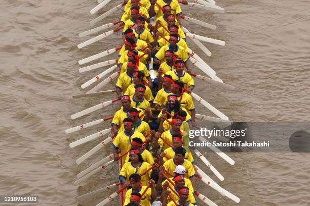 Cambodian dragon boat crew members row their boat on the Tonle Sap river during the final day of the Water Festival boat race. The country's annual...