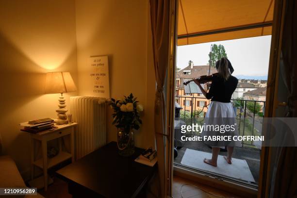 Prize-winner of international competitions, Moldavian violin solist Alexandra Conunova plays a concert from her balcony for her neighbours on April...
