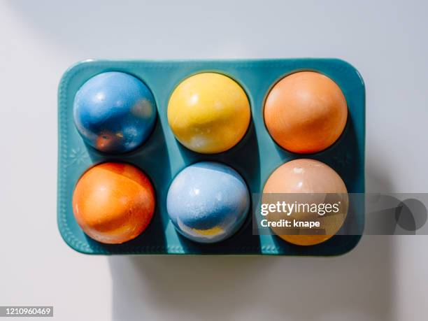 naturally colored easter egg in easter egg holder from above overhead - food coloring stock pictures, royalty-free photos & images
