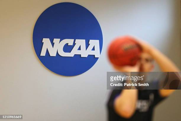 The NCAA logo is seen on the wall as Yeshiva players warmup prior to playing against Worcester Polytechnic Institute during the NCAA Division III...