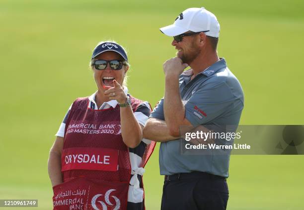 David Drysdale of Scotland laughs with wife and caddie Vicky Drysdale on the 17th green during the third round of the Commercial Bank Qatar Masters...