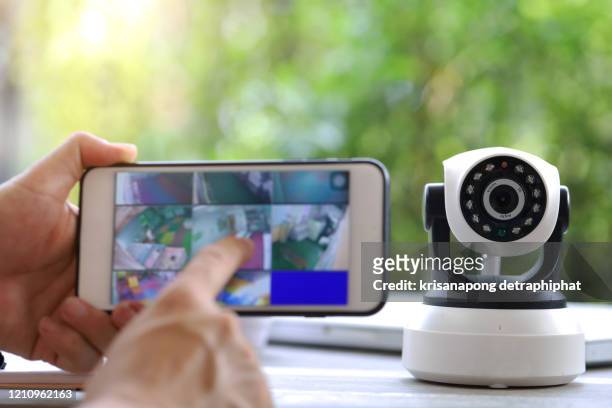 male hand press phone watch cctv - security camera stock pictures, royalty-free photos & images