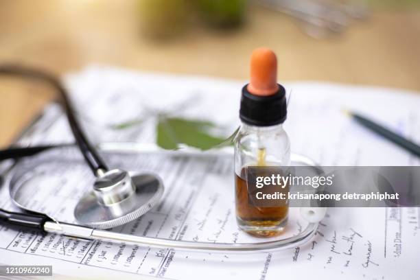 marijuana research,the hands of scientists dropping marijuana oil for experimentation and research,,hemp oil - oli aromi e spezie foto e immagini stock