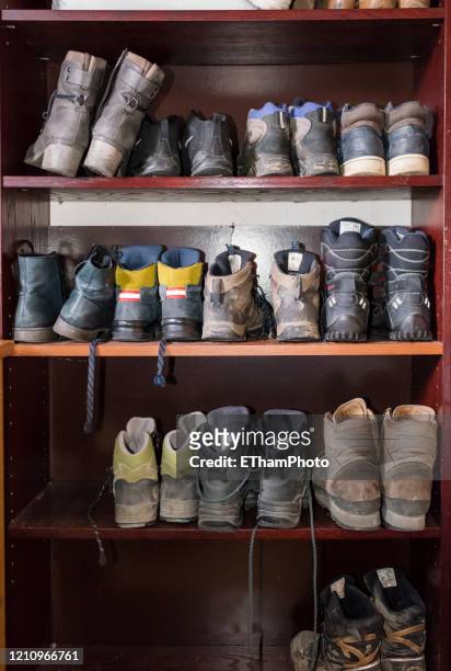 storage of many differnt used shoes on a shelf in the attic of a domestic home - attic storage stockfoto's en -beelden
