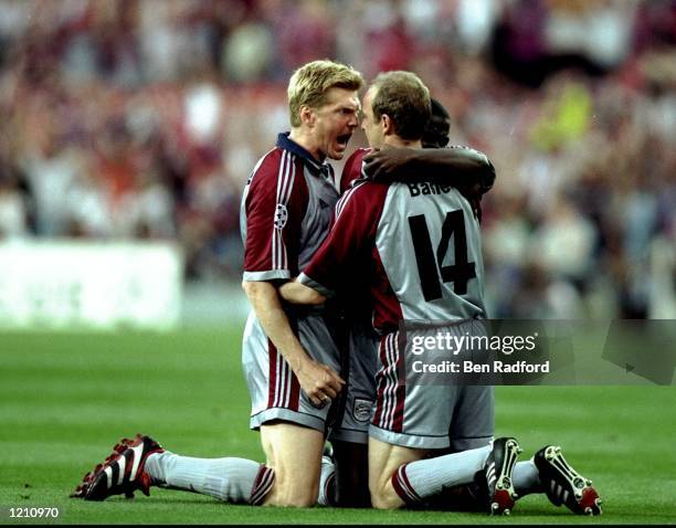 Steffan Effenberg , Samuel Kuffour and Mario Basler of Bayern Munich celebrate Basler's sixth minute goal from a free kick during the Champions...
