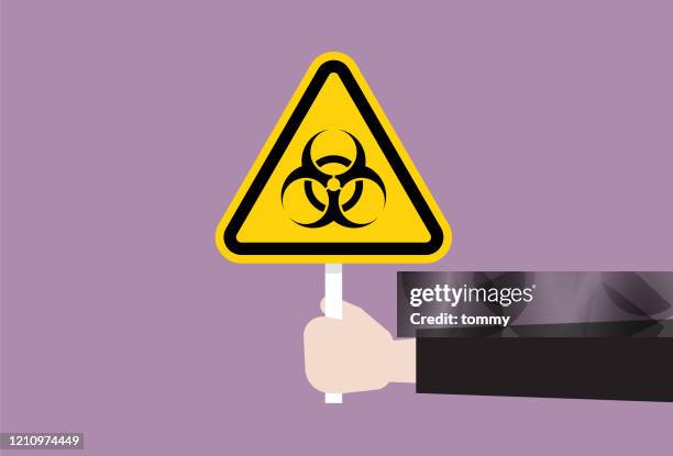 the human hand holds a biohazard symbol - keep out sign stock illustrations