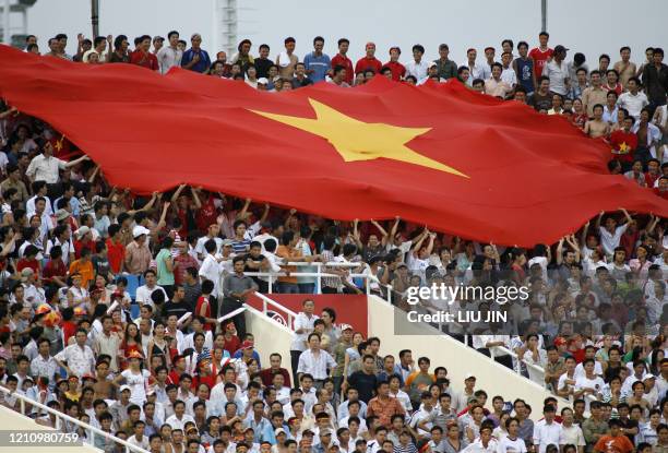 Vietnamese football fans show their support with a huge flag on the grandstand during the Asian Football Cup group B match between Japan and Vietnam...