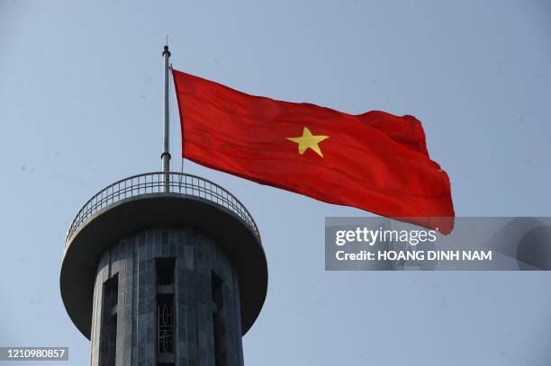 This picture taken on March 8, 2012 shows Vietnamese flag flying atop Lung Cu flag tower located at the Northernmost point of Vietnam near to the...