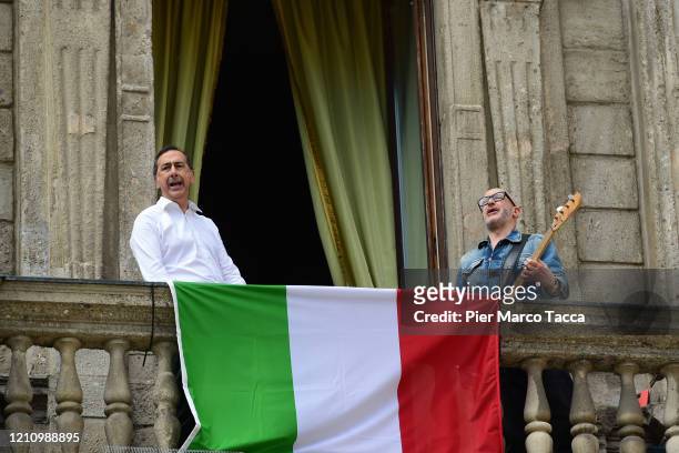 The Mayor of Milan Giuseppe Sala and composer Saturnino sing 'Bella Ciao' song from the balcony of Palazzo Marino during the celebration ceremony on...